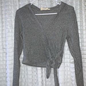 grey tie low cut sweater